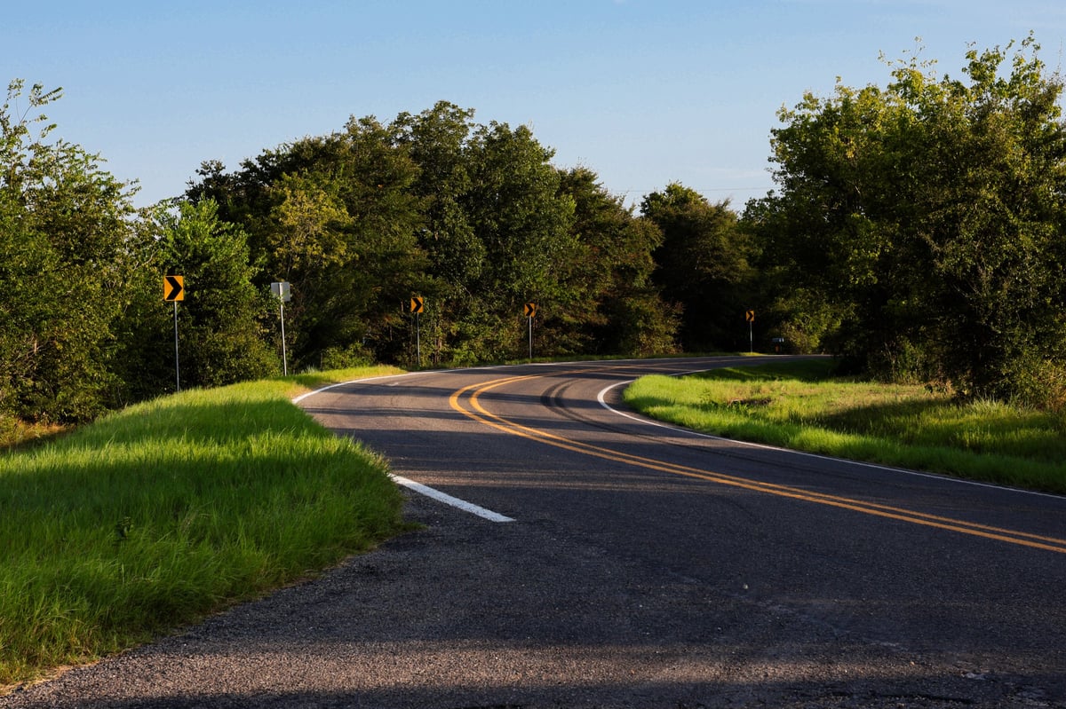 Scenic rural Texas road curving through golden countryside